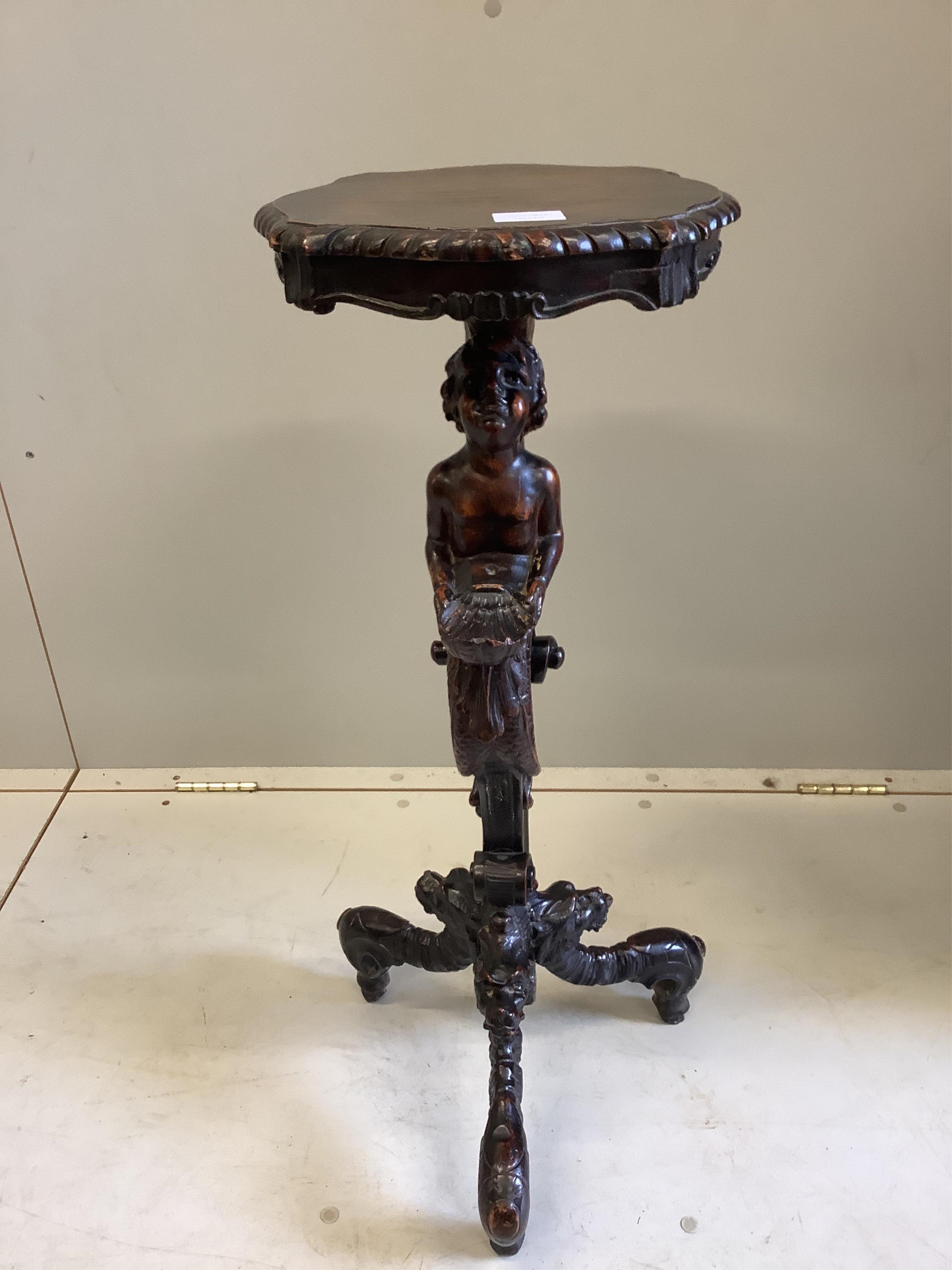 An Italian carved walnut cherub and shell torchere, height 81cm. Condition - good